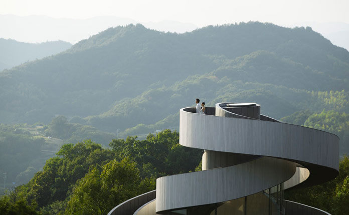 A wedding couple is enjoying the view from the highest point.